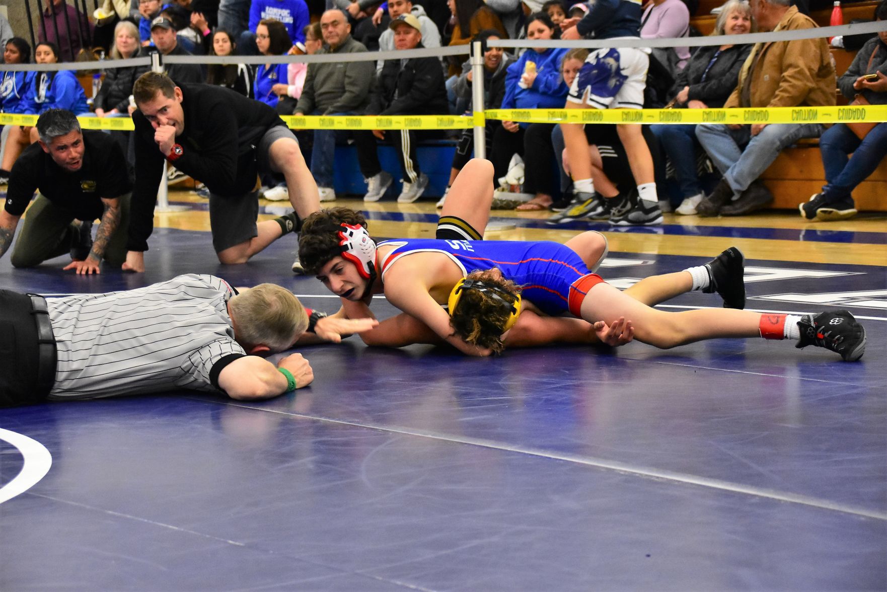 San Marcos' Levi Cooper (Top) scores a pin on Cabrillo's Aiden Bumanglag
